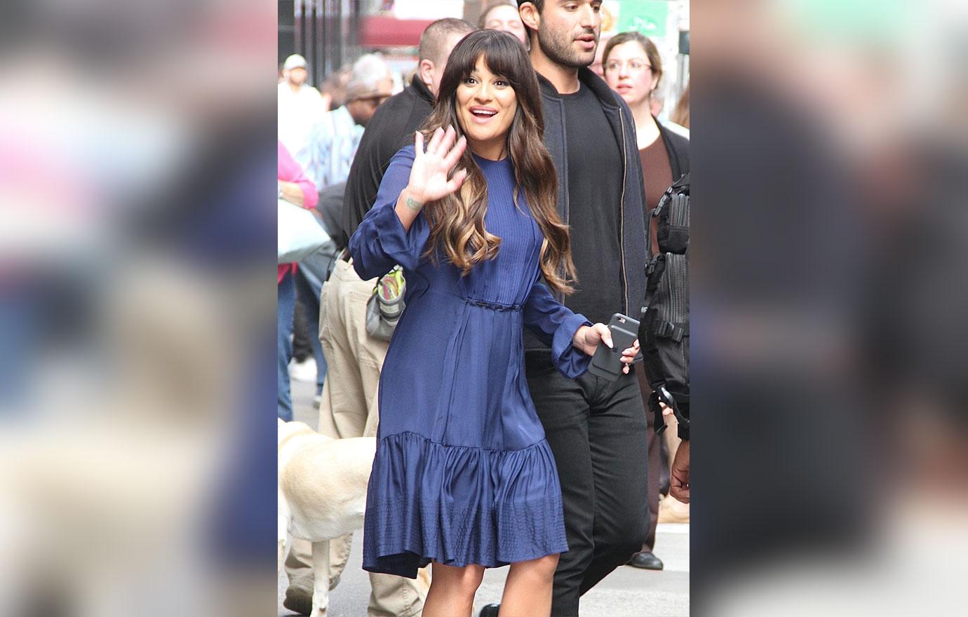 Lea Michele waves to her fans as she leaves Good Morning America