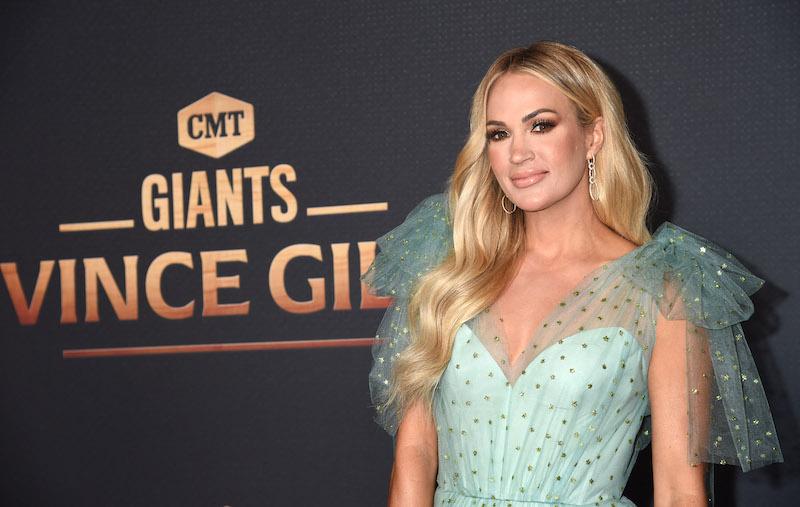 Carrie Underwood is joined by husband Mike Fisher on the red carpet at the CMA  Awards, where she will be participating in three separate