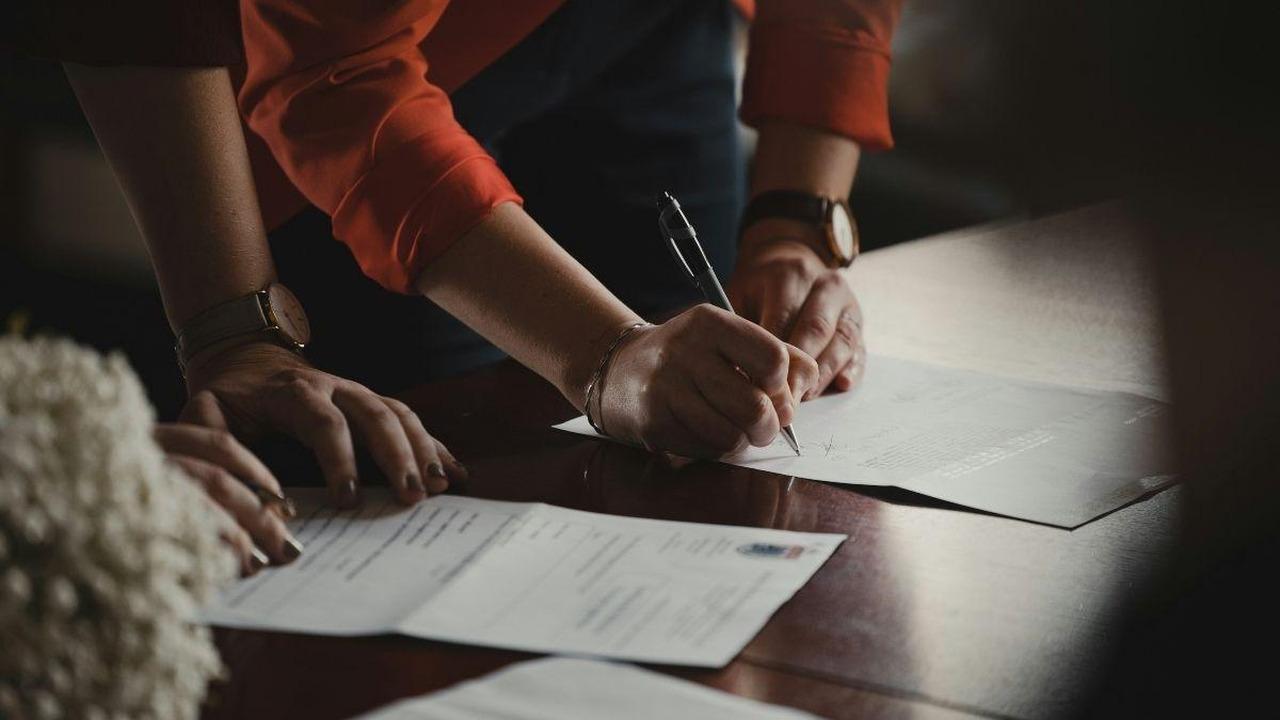 Image of prisoner signing documents