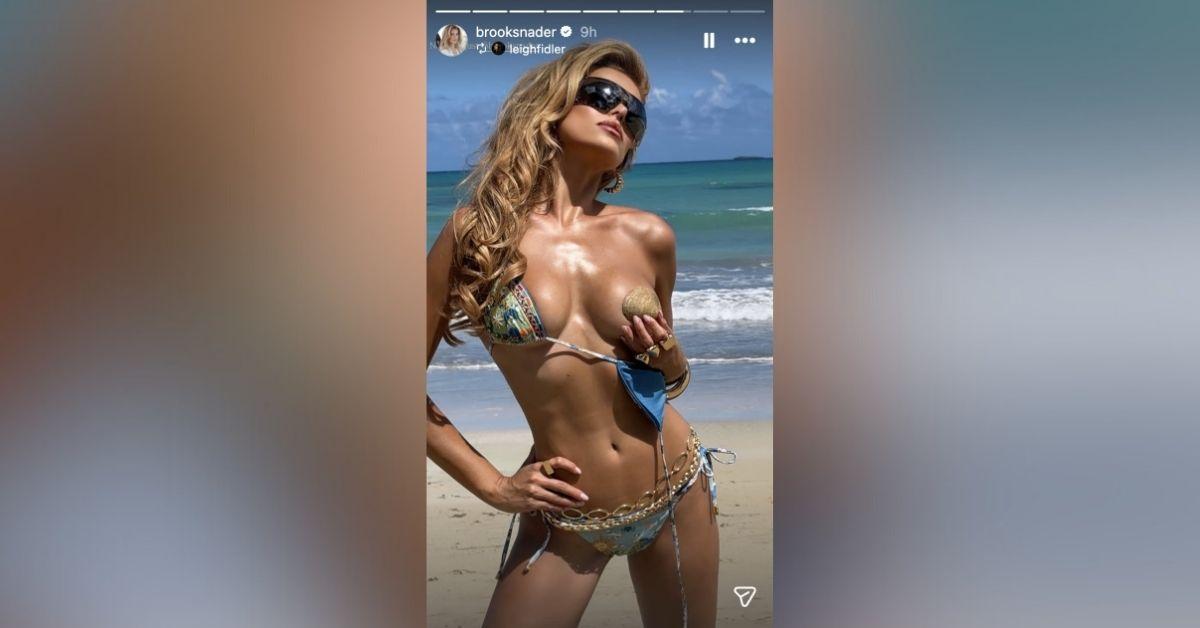 image of Brooks Nader posed in a daring bikini on the beach.