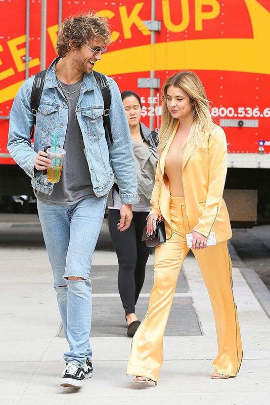 Ashley Benson stands out in a golden orange satin outfit