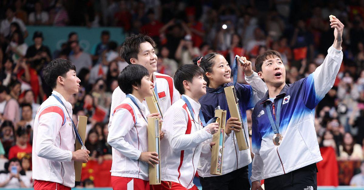 north and south korean athletes shared the podium