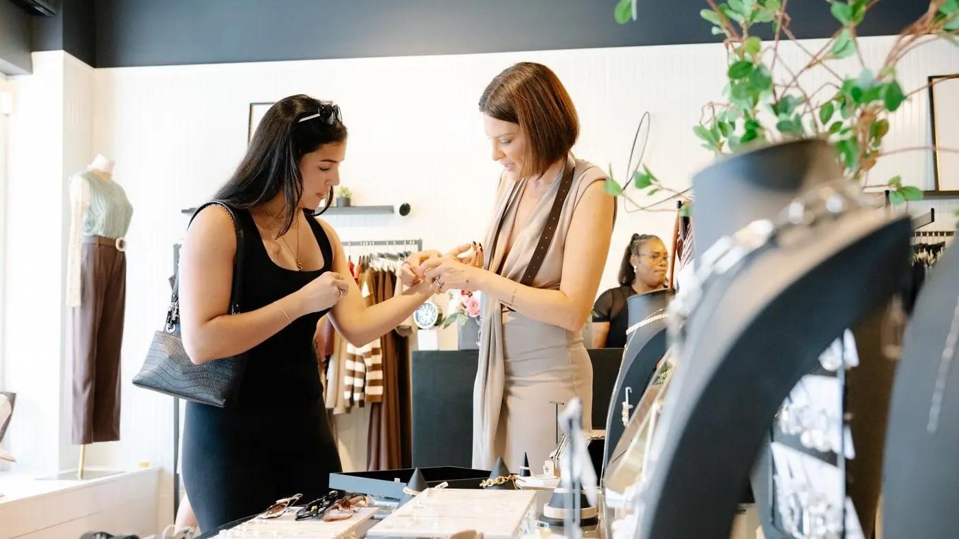 Photo of Lindsay Rose Rando and a customer.