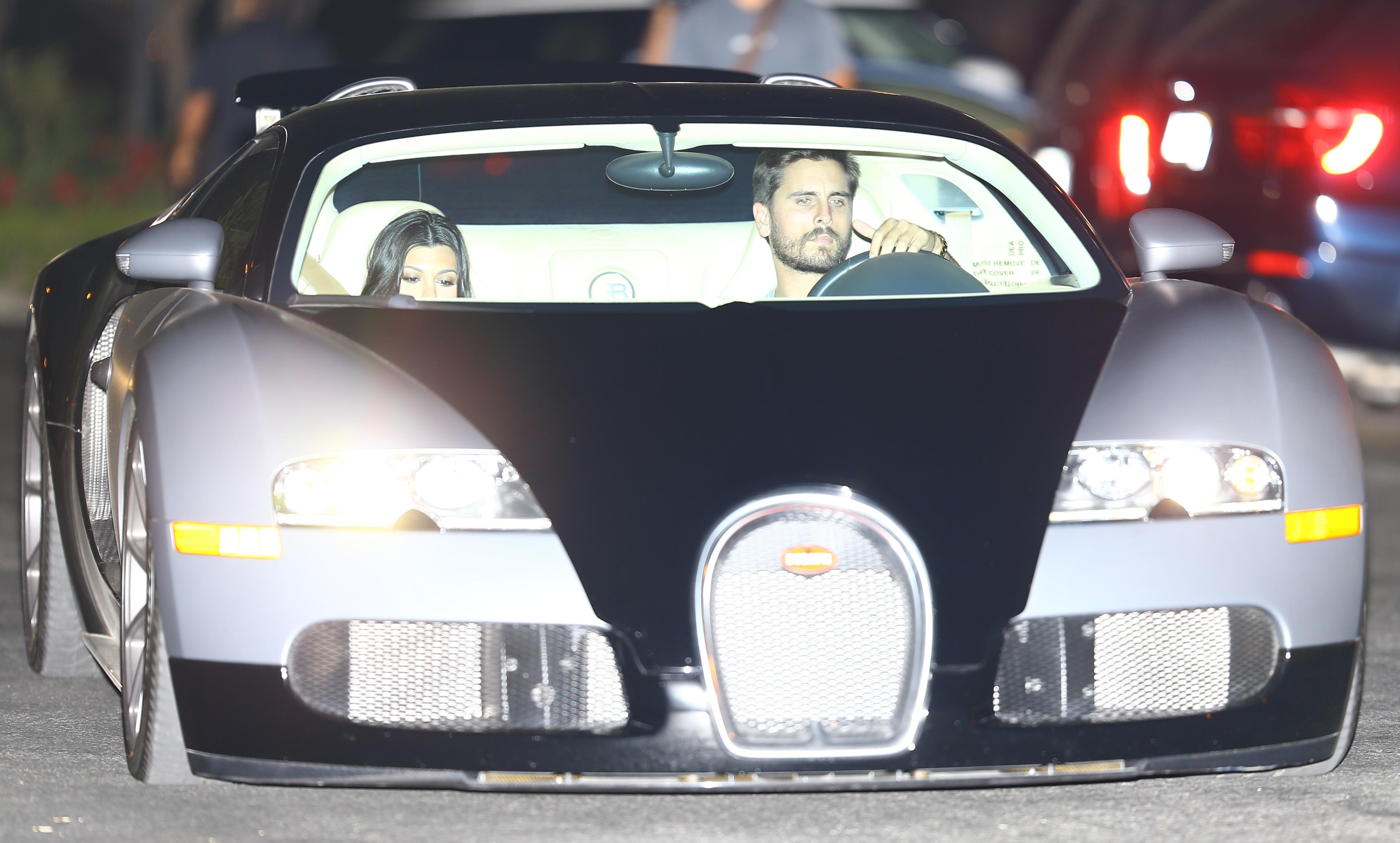 Pregnant Kourtney Kardashian and Scott Disick drive their new Bugatti to dinner