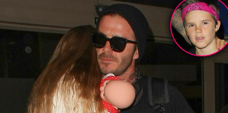 David Beckham carries a sleeping Harper as Romeo gives stylish mum