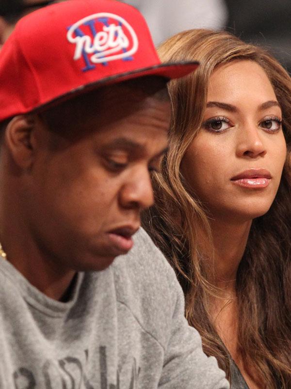 Jay Z and Beyonce sitting in the front row at the Toronto Raptors vs. Brooklyn Nets at the Barclays Center