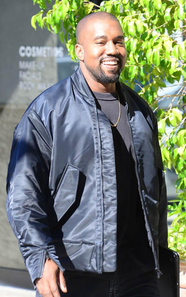 Kanye West cracks a rare smile as he heads to North Wests dance class in Tarzana, Ca