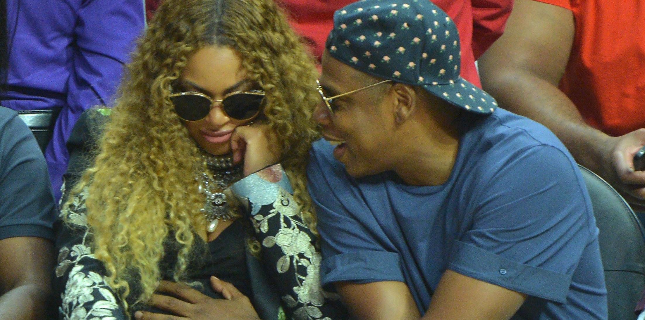 Excited parents Beyonce and Jay Z get distracted by their unborn twins at the LA Clippers game