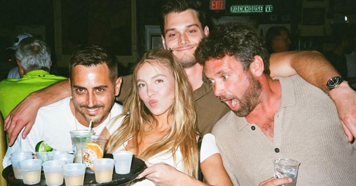 Photo of Sydney Sweeney with three men