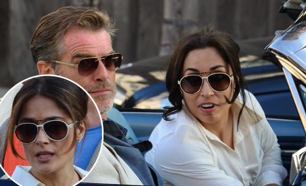 Pierce Brosnan makes some animated faces while sitting with Salma Hayeks&#039;s stunt double on the set of &#039;How To Make Love Like An Englishman&#039; which was filming in Venice, CA