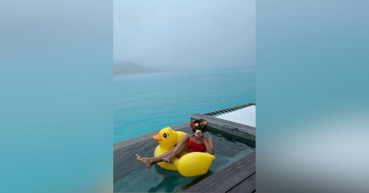 image of The actress wore a flower crown as she relaxed on a duck float.