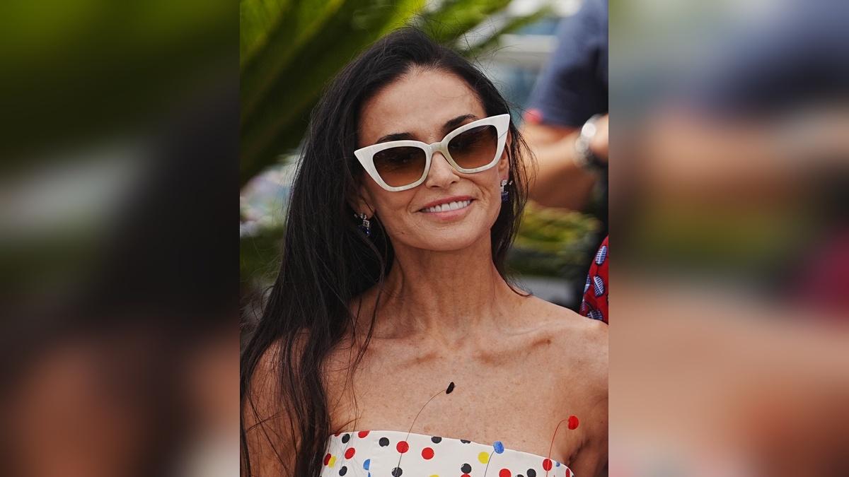 Image of Demi Moore accessorized her playful look with cat-eye sunglasses.