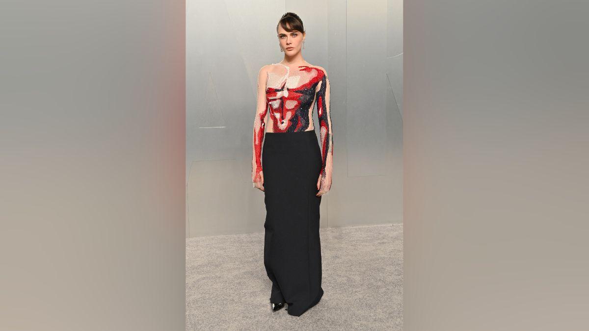 Image of Cara Delevingne wore a painted muscle dress.