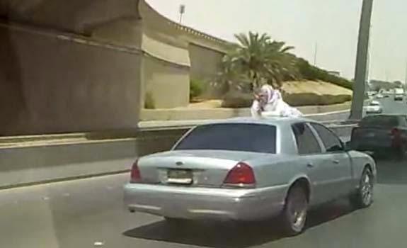 //saudi_man_texting_car_hood_freeway_stack_