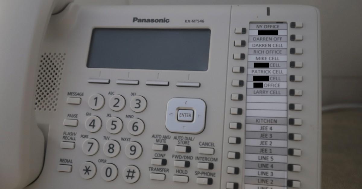 Image of Certain names were redacted from a landline telephone.
