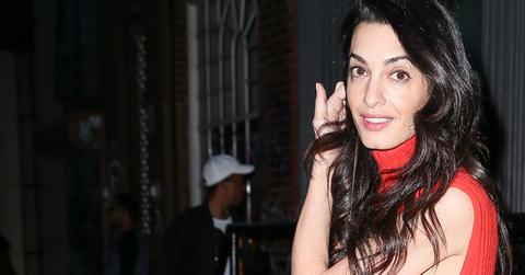 Amal Clooney steps out in a style wearing, mini red dress and floral boots in SoHo, New York City