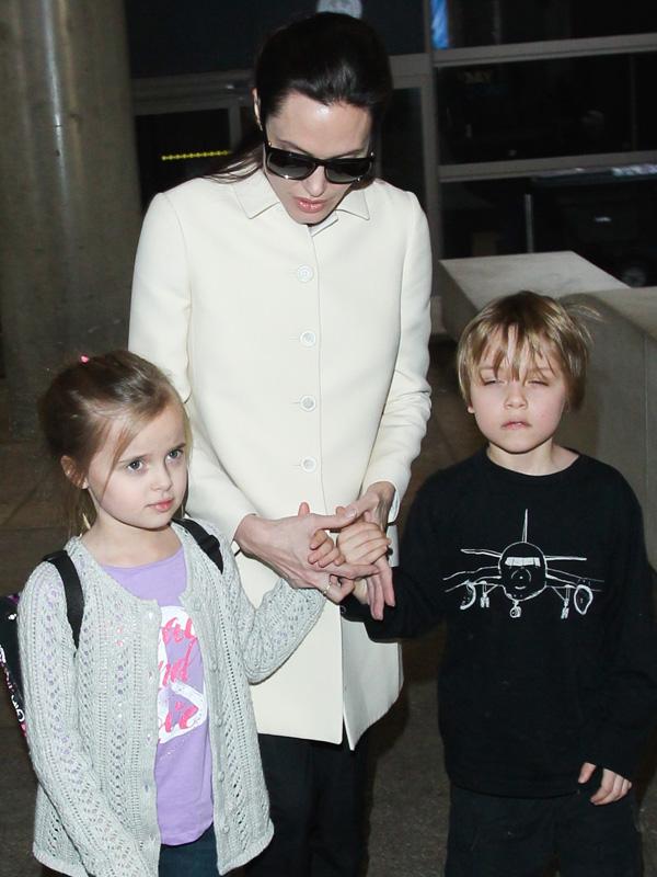 Angelina Jolie, Knox and Vivienne hold hands at LAX **USA ONLY**