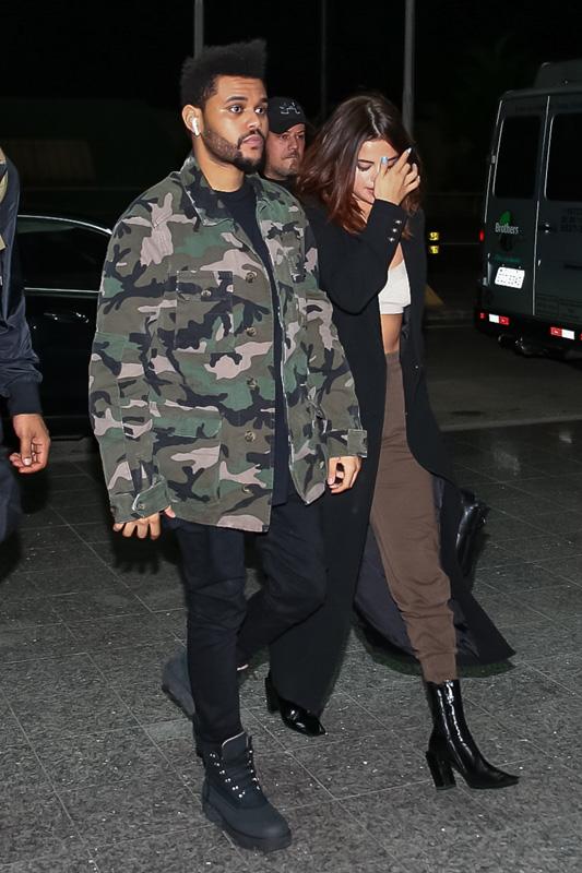 *EXCLUSIVE* The Weeknd and Selena Gomez keep close on their way to a flight after Lollapalooza Brazil