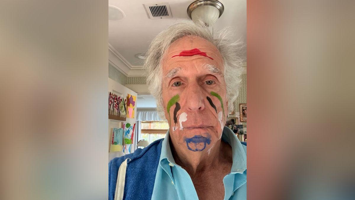 Photo of Image of Henry Winkler goofed off with his grandchild as she painted his face.