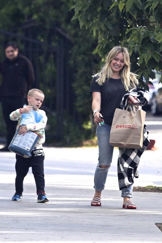 *EXCLUSIVE* Hilary Duff gets some help from Luca carrying the dog food