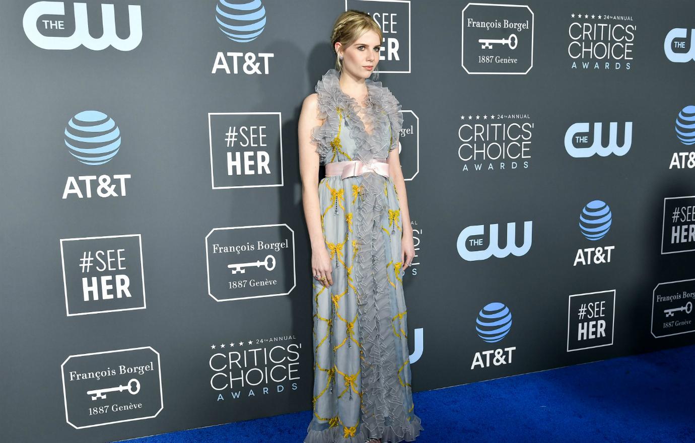 Lucy Boynton in a light blue patterned dress on the red carpet.