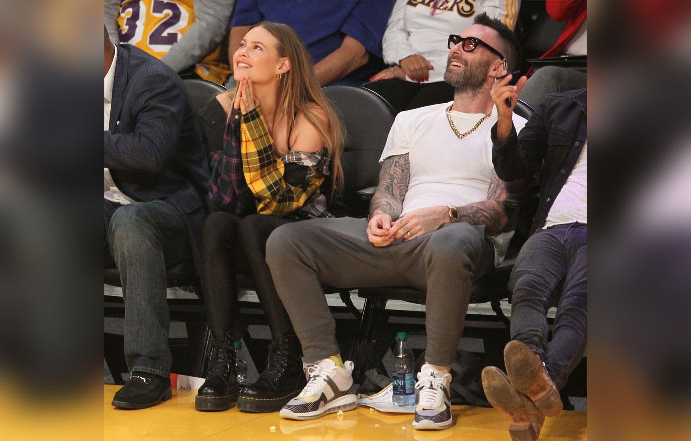 Adam Levine and Behati Prinsloo watch the Los Angeles Lakers play the Houston Rockets