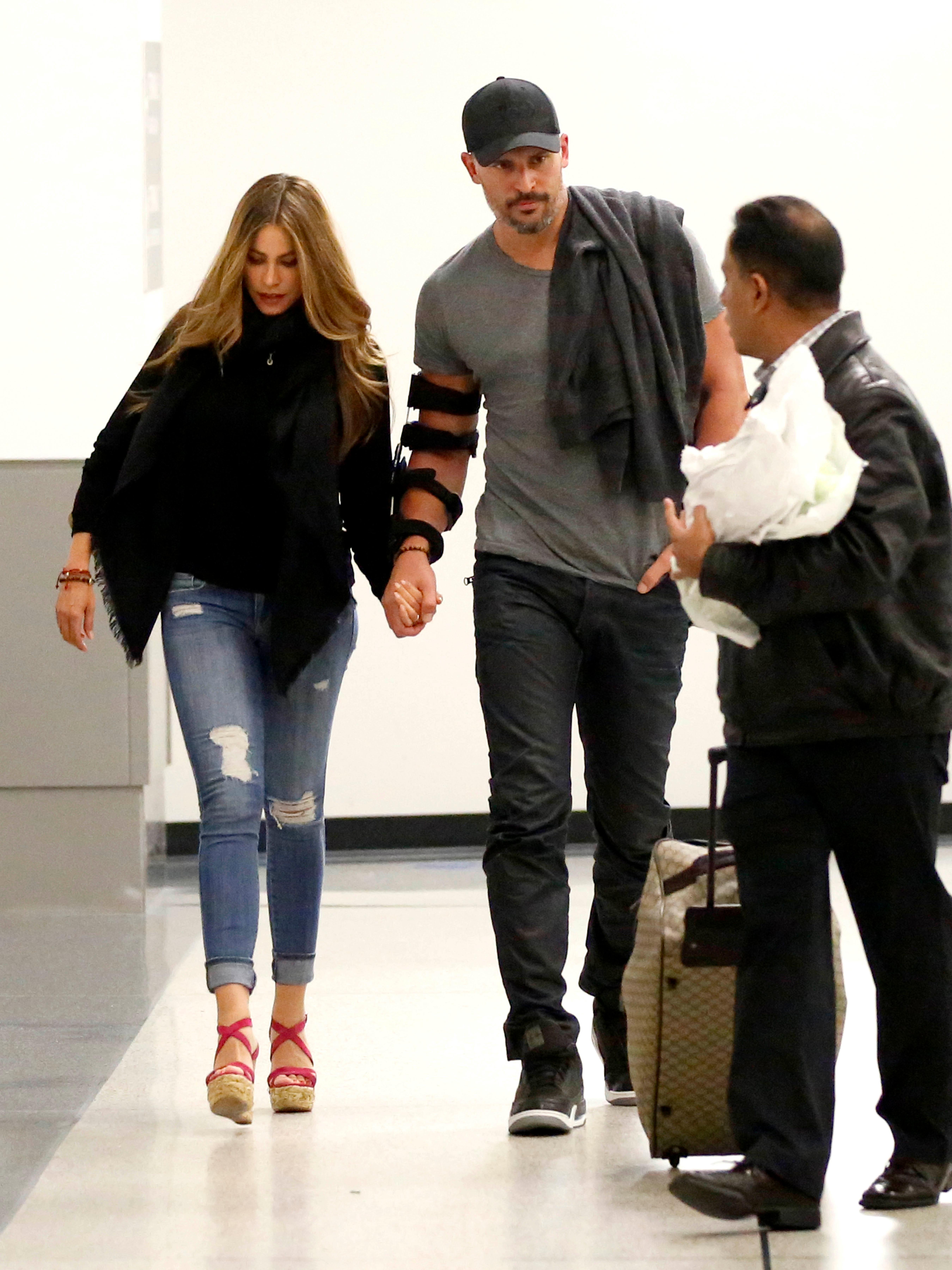 EXCLUSIVE: Newly engaged couple Sofia Vergara and Joe Manganiello walk hand in hand as they arrive back in Los Angeles