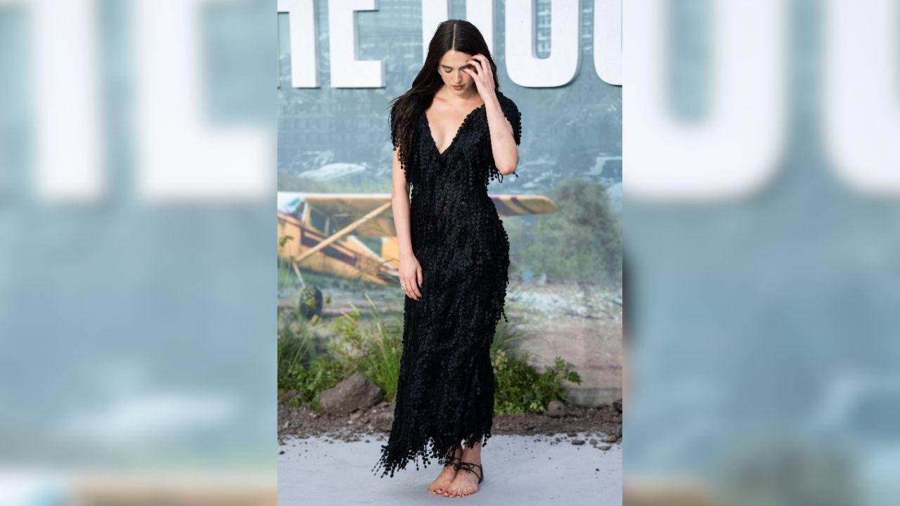 Image of She paired the Chanel footwear with a fringed black dress.