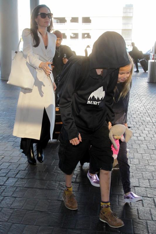 Angelina Jolie makes sure her kids are all in line at LAX