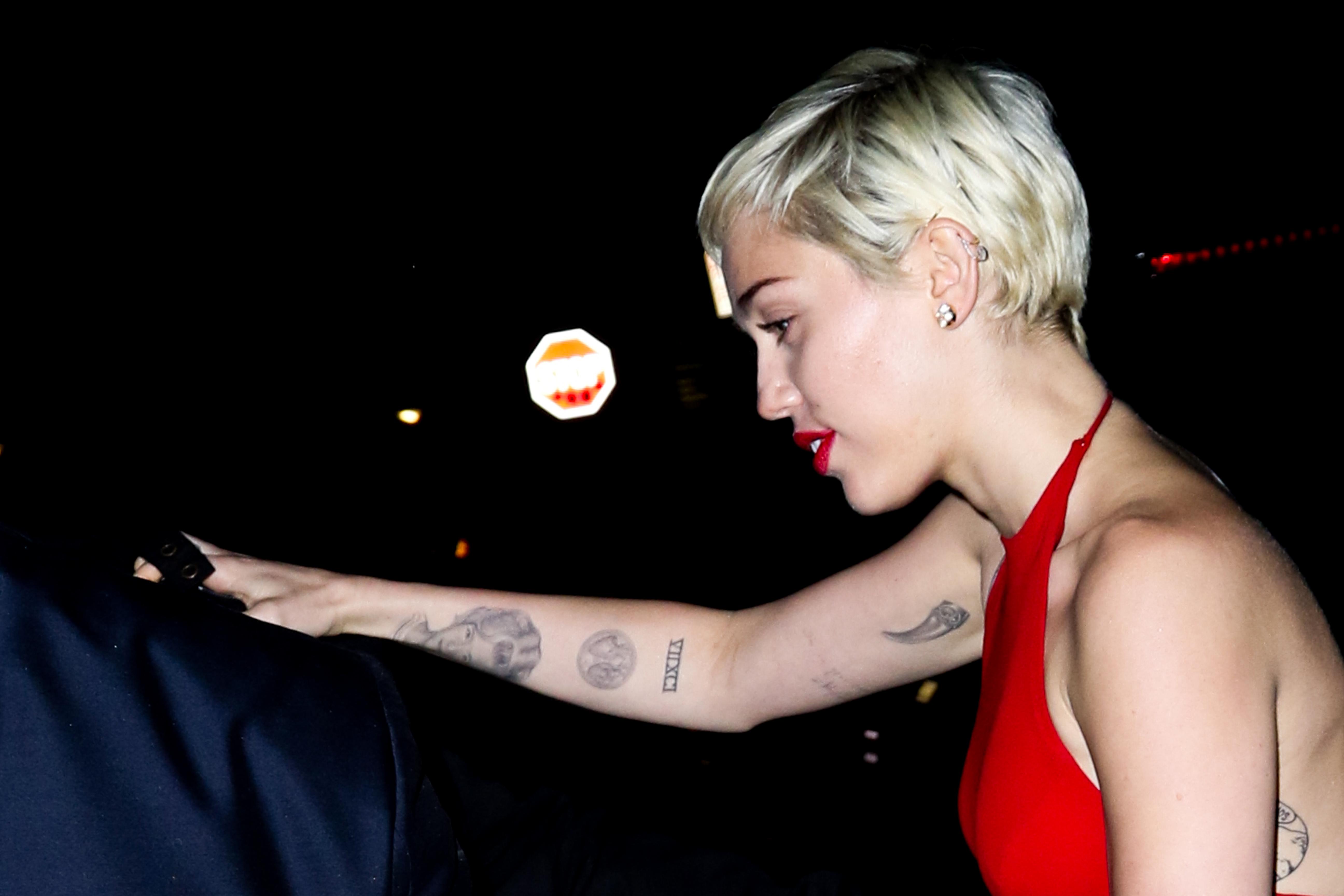 Miley Cyrus seen exiting through the back alley exit of Hooray Henry&#8217;s nightclub