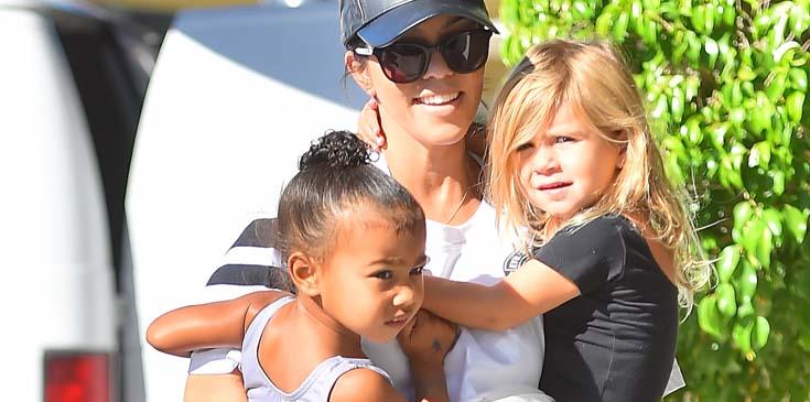 Kourtney Kardashian carries North and Penelope to dance class