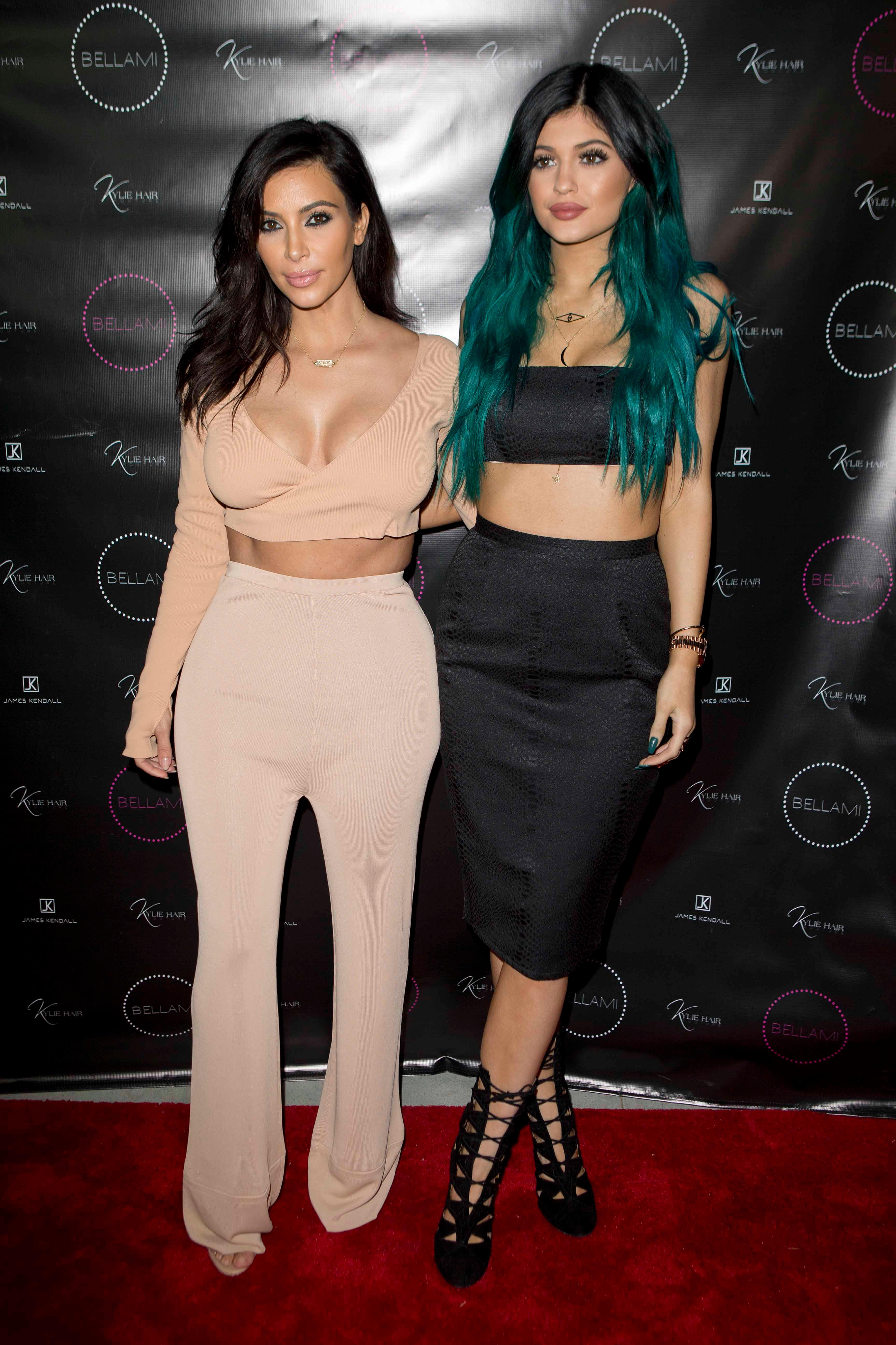 Kylie Jenner poses happily with her sisters on her big hair line extension night launch party LA