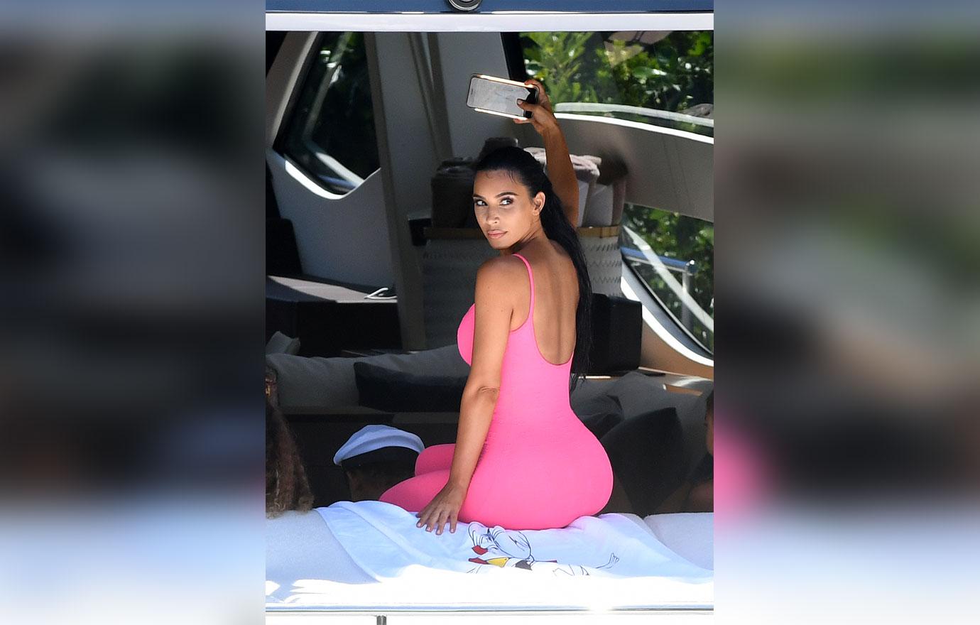 Kim Kardashian wears a hot pink catsuit as she takes her kids on a yacht in Miami