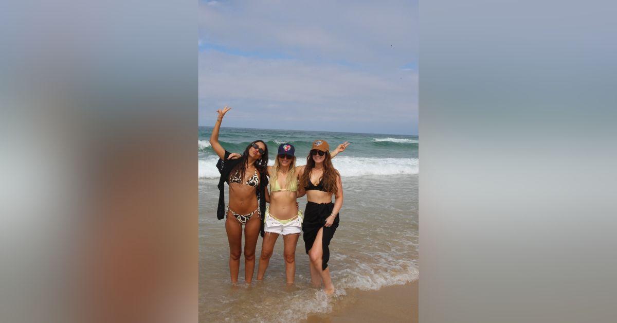 Image of Jessica Alba soaked in the sun at the beach with friends.