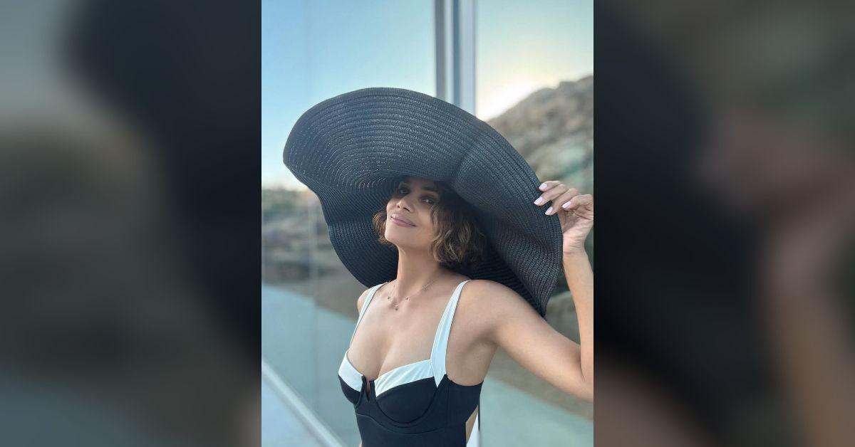 halle berry flaunts ageless physique cleavage baring swimsuit photos