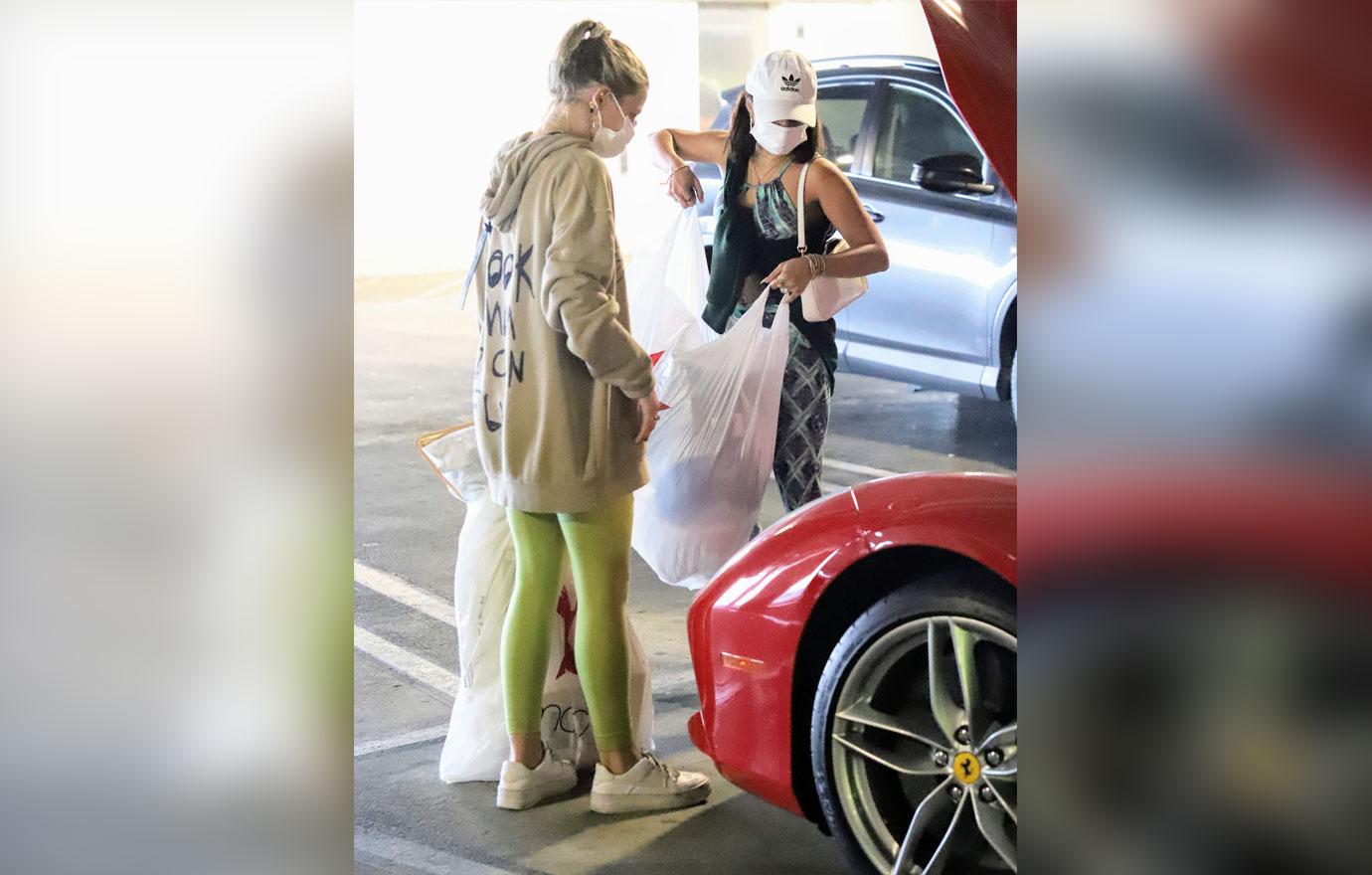 Vanessa Hudgens stuffs her Ferrari after early holiday shopping at the mall.