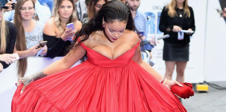 Rihanna Struggles With Her Boobs Popped Out In Low-Cut Scarlet