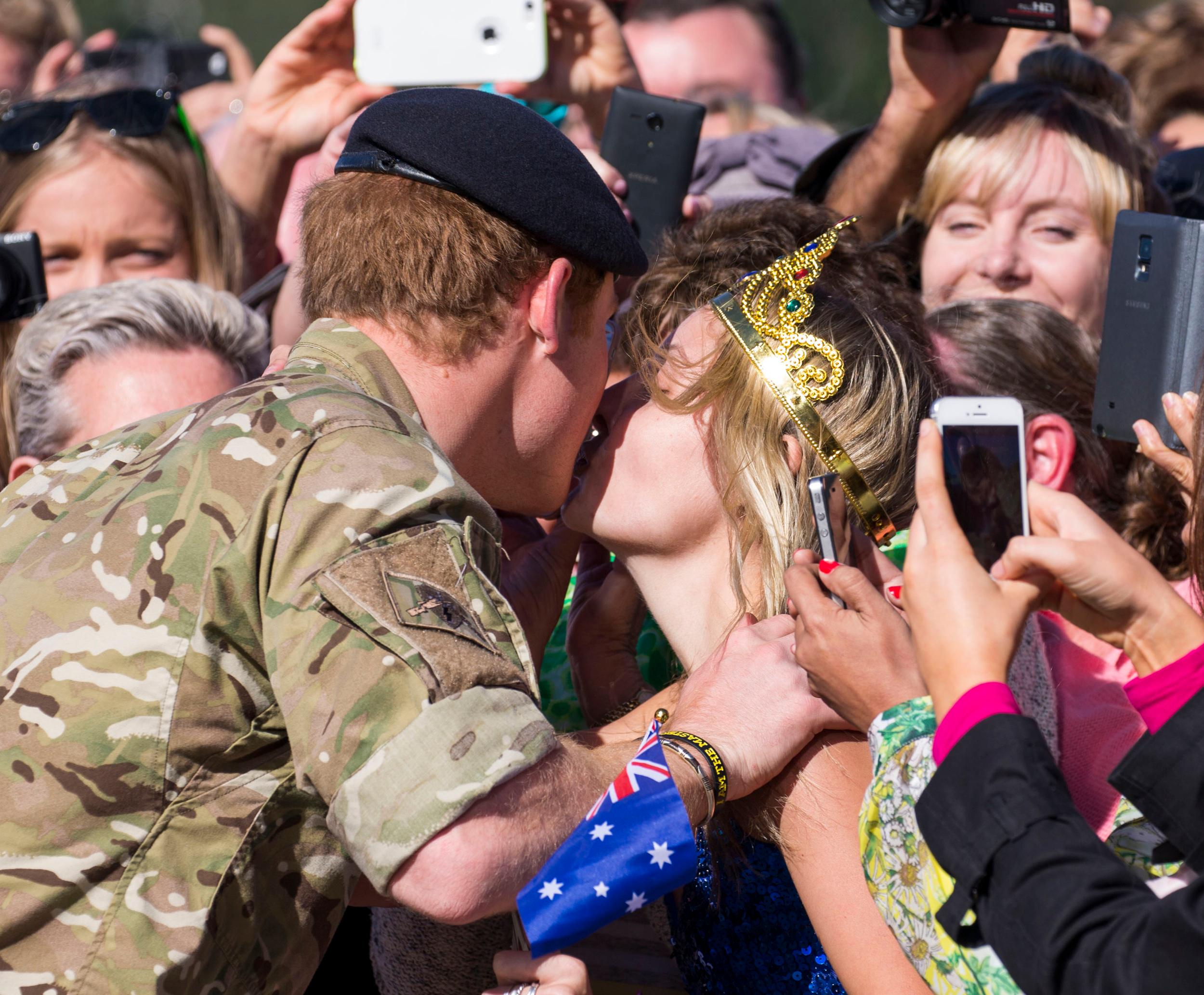 Prince Harry plants a kiss on an adoring fan! **USA ONLY**