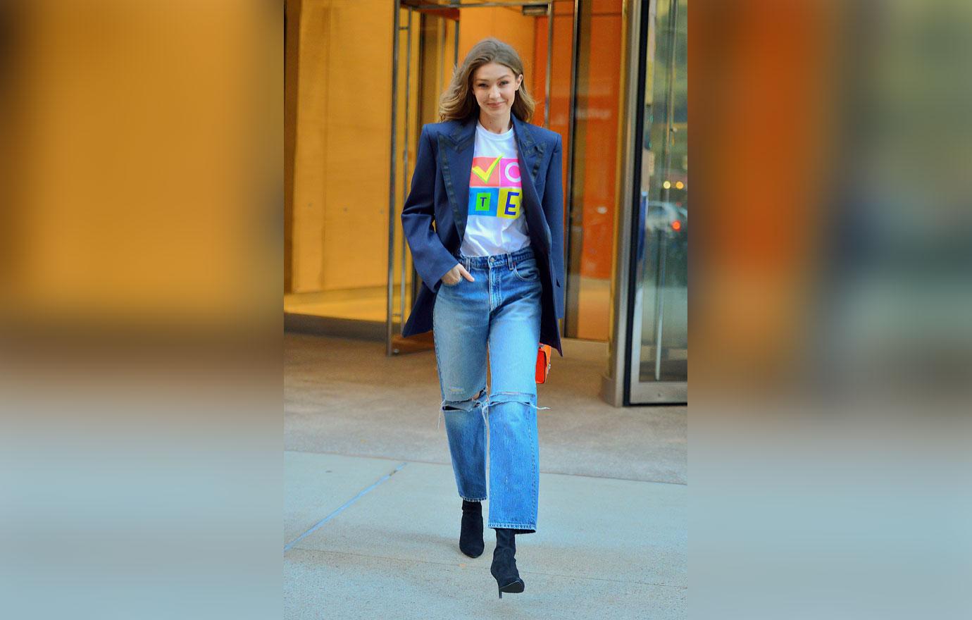 Gigi Hadid is all smiles showing off her VOTE t shirt as she leaves Victoria Secret fashion show fittings in NYC