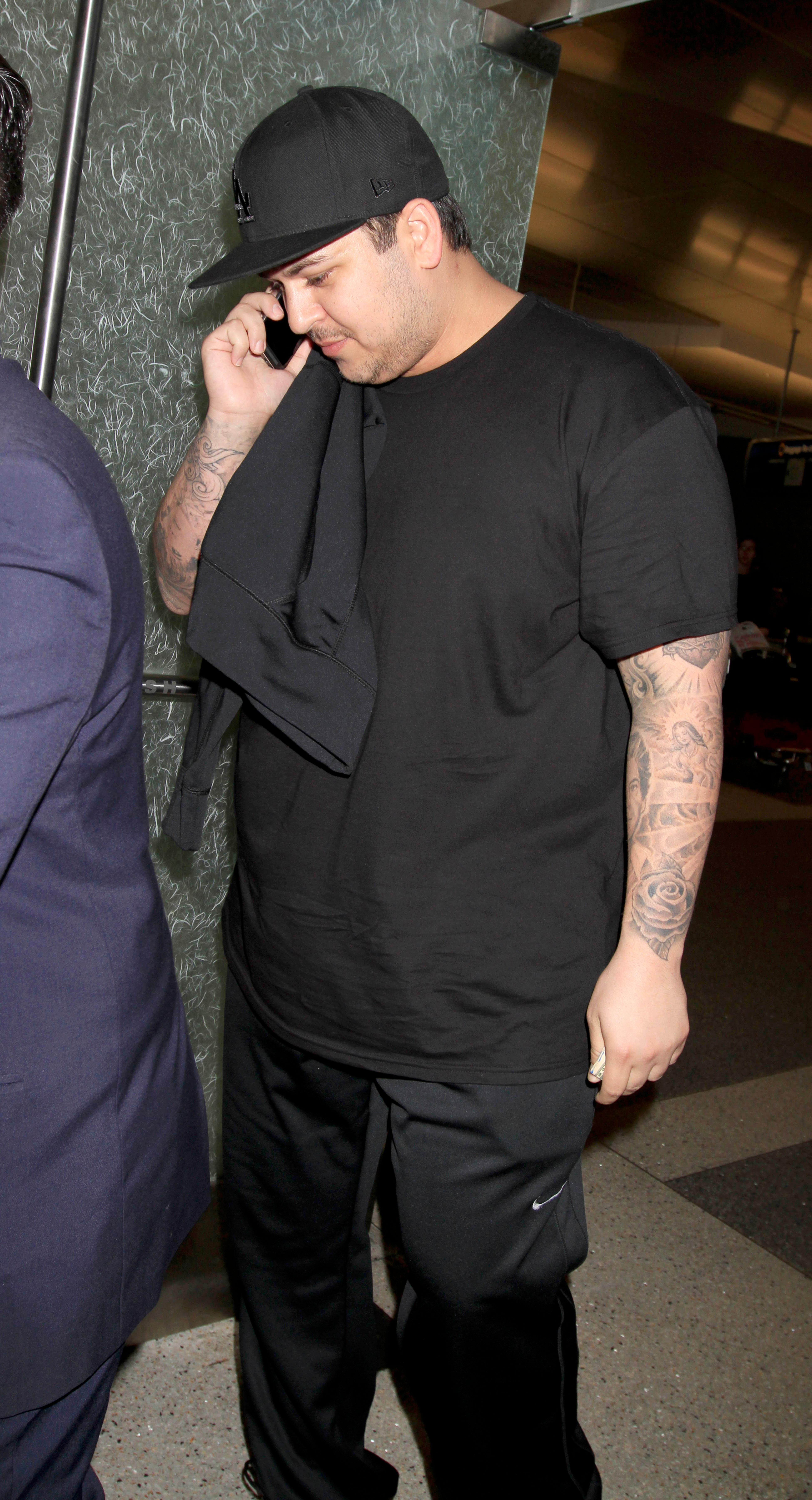 Rob Kardashian skips his sister&#8217;s wedding amidst reports there was a family clash as he is seen at LAX on the same day Kim Kardashian is due to get married to Kanye West at the Palace of Versailles