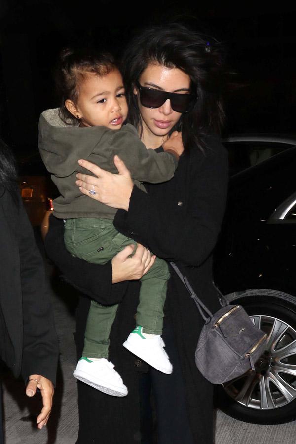 Kim Kardashian shows off her diamond ring as she jets out of JFK with family **NO UK**