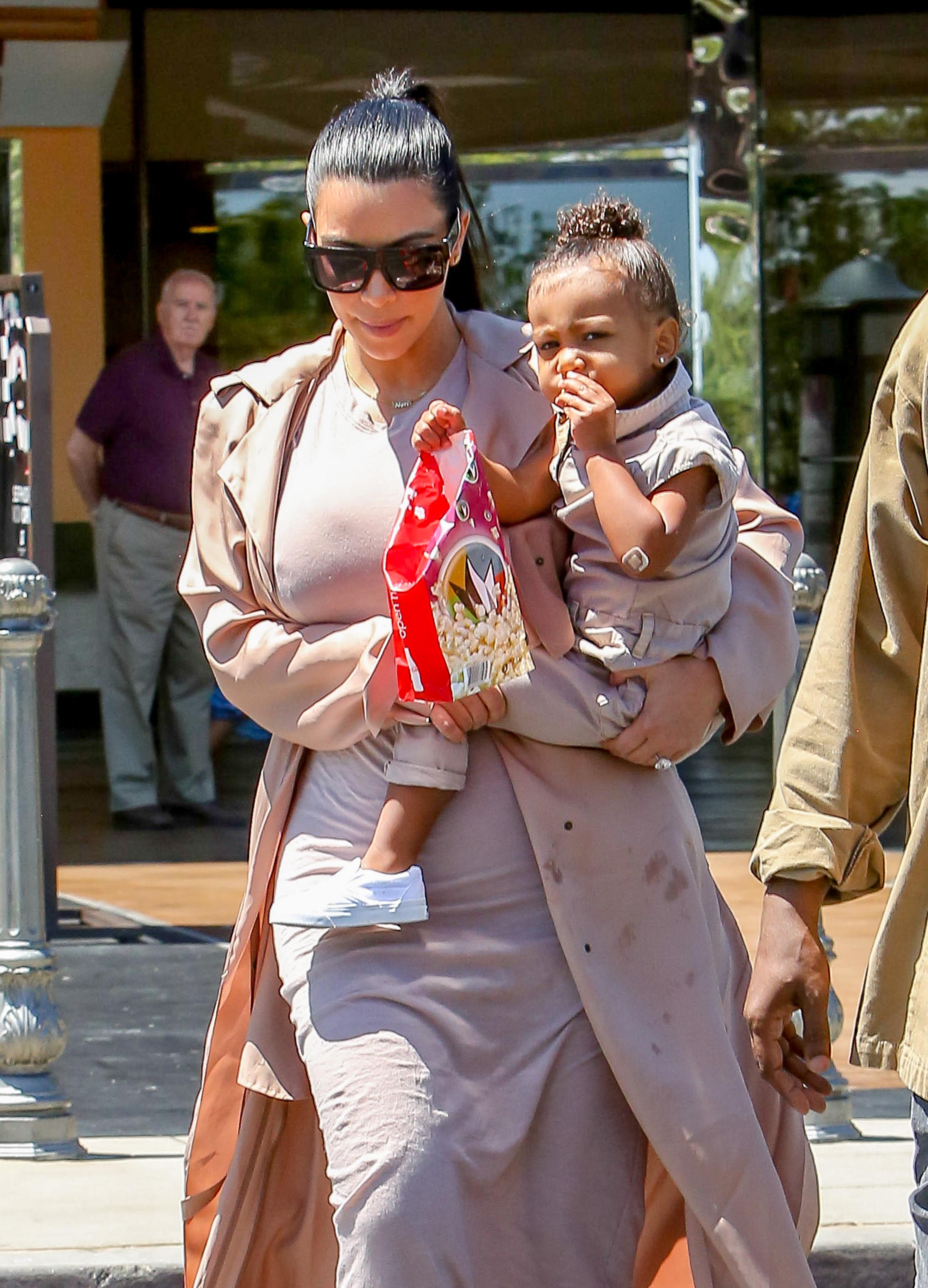 Kim Kardashian and Kanye West take their baby North West to the movies in Calabasas, CA