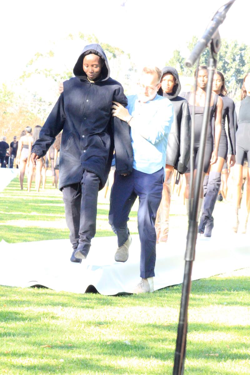 Kanye West seen helping model walk during his Yeezy Fashion Show in