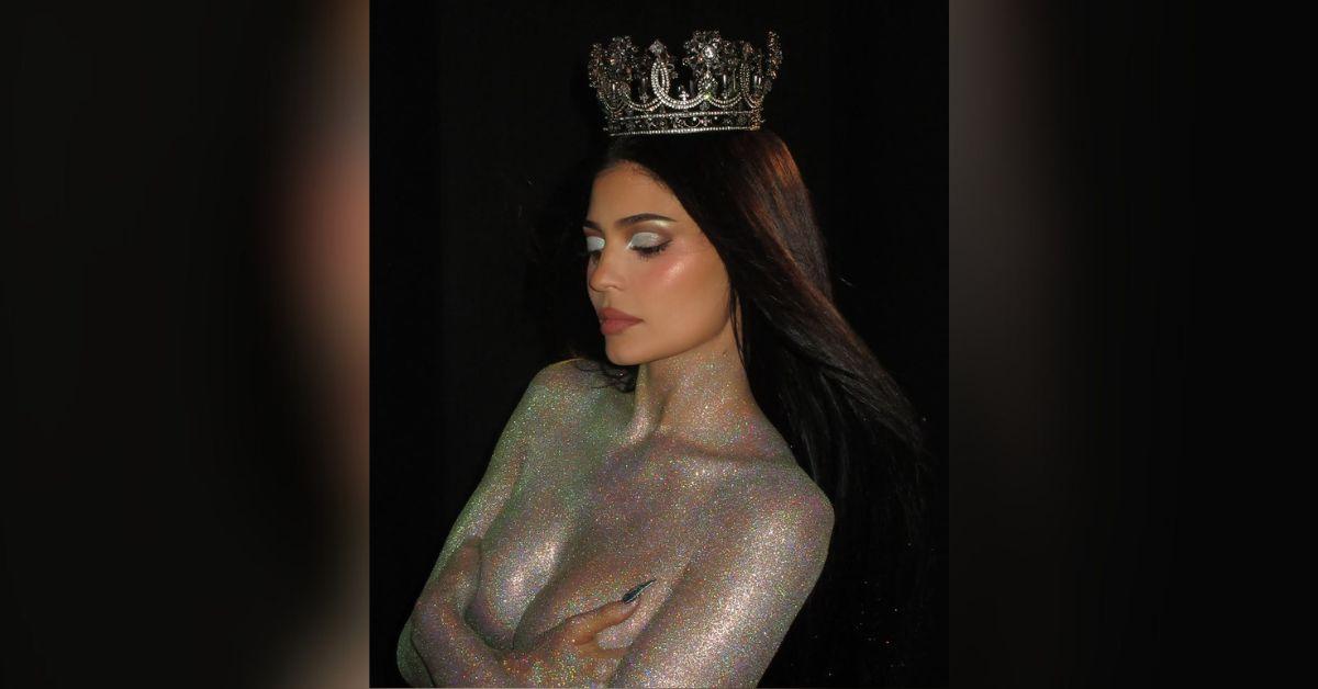 image of Kylie Jenner covered her b----- with her hands. 
