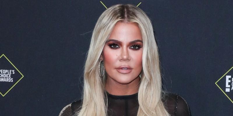 Khloe Kardashian Wearing a Black Dress On a Red Carpet