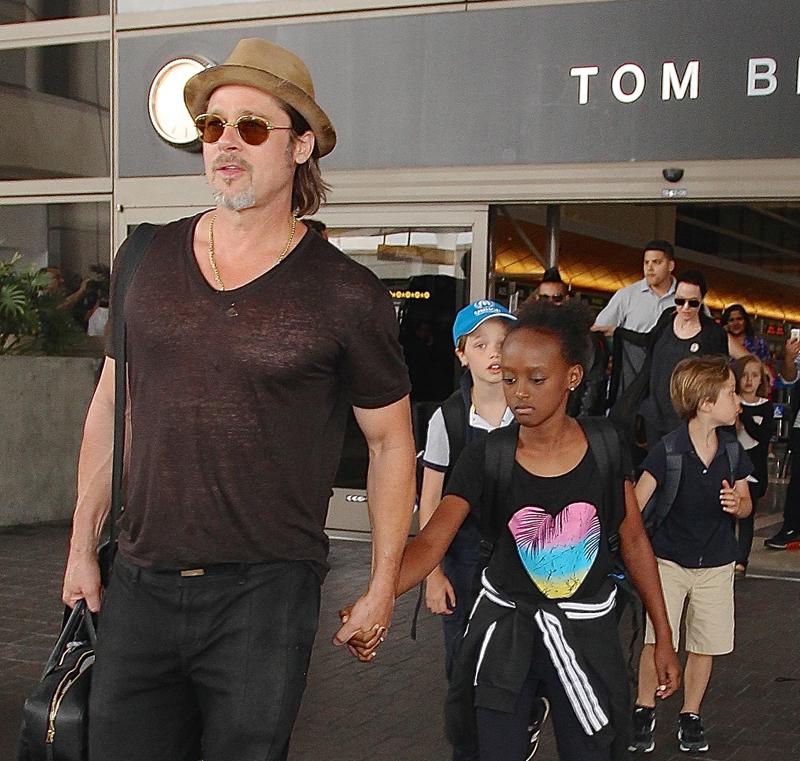 Brad Pitt and Angelina Jolie arriving on a flight at LAX with their children