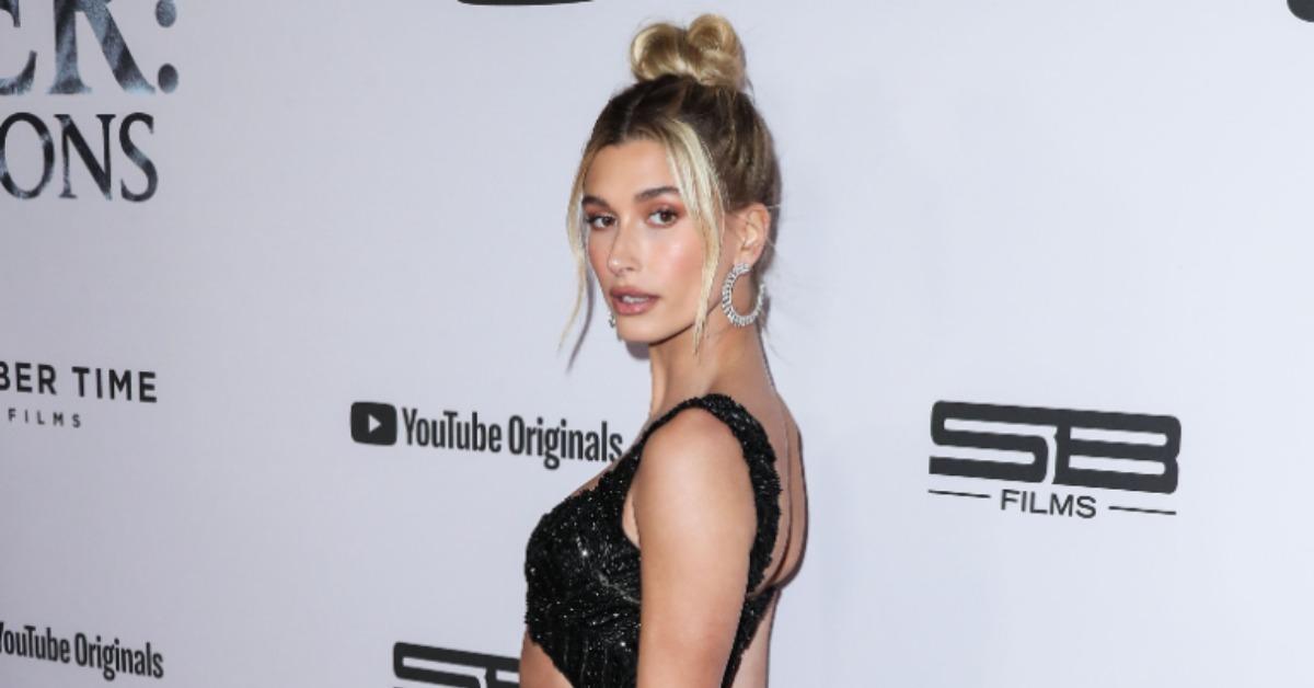 Hailey Bieber poses sensually in orange Balenciaga sweatsuit for