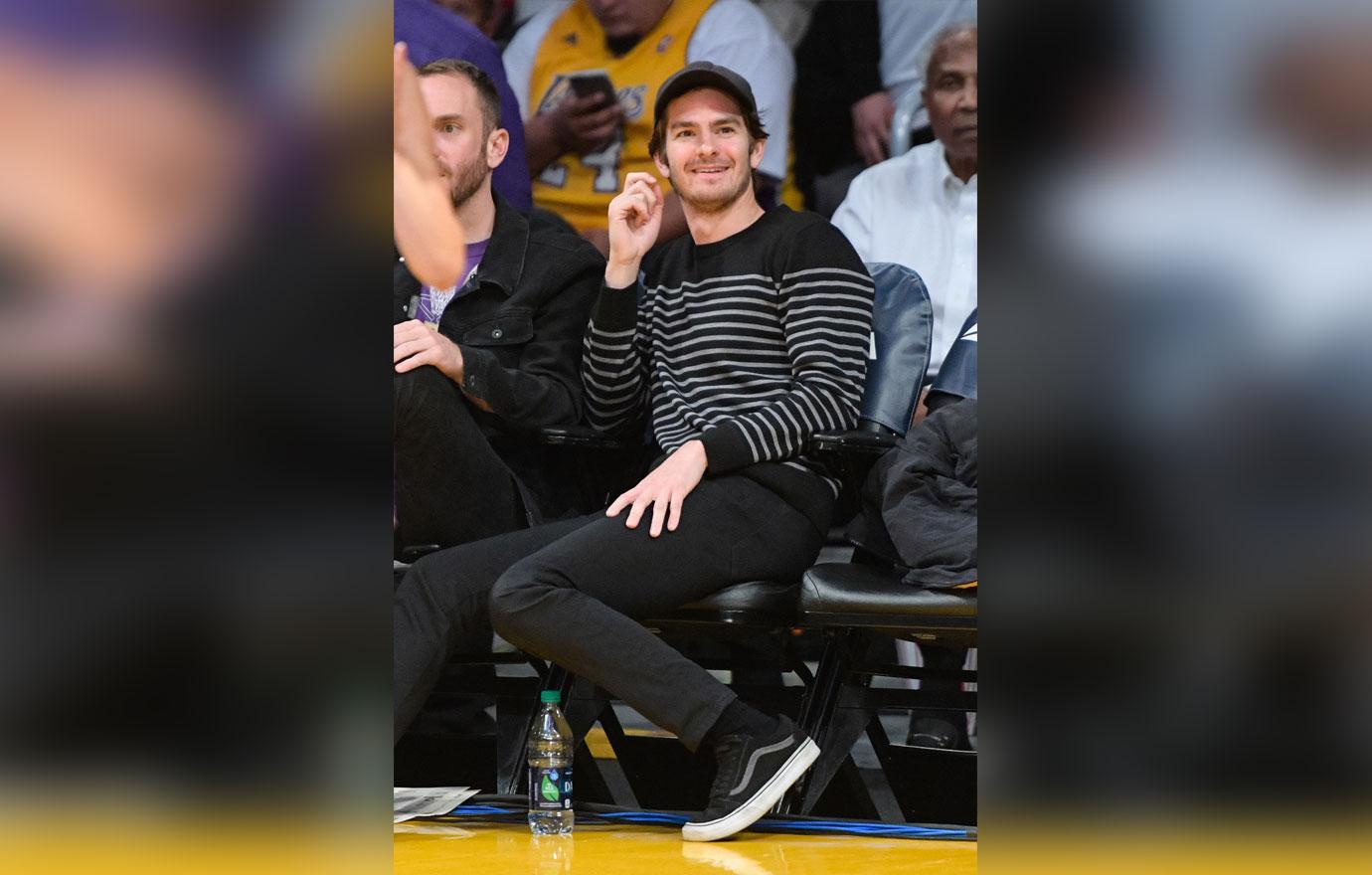 Andrew Garfield in a black and white sweater at a Lakers game.