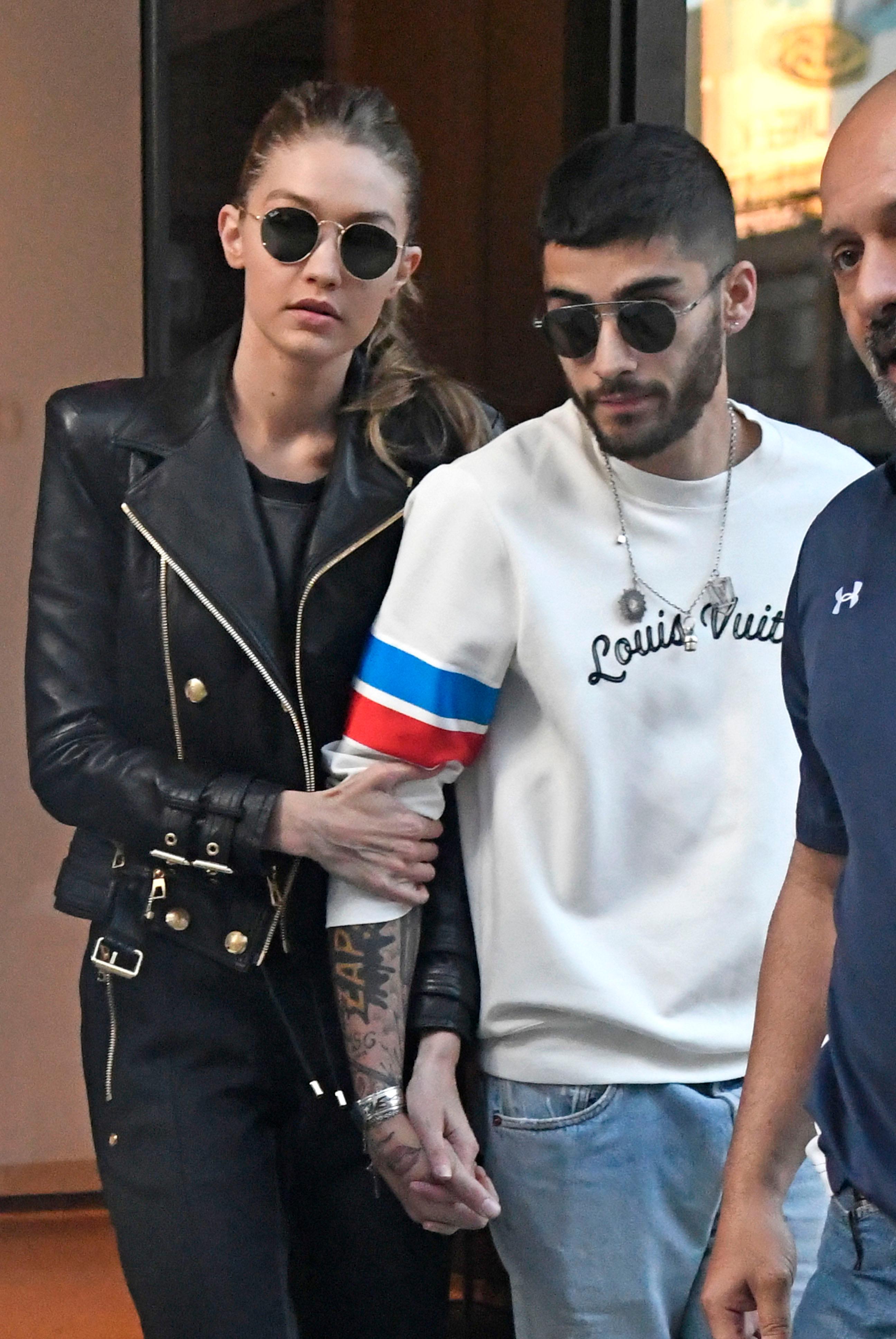 Gigi Hadid and Zayn Malik hold hands while exiting their apartment in NoHo in New York City