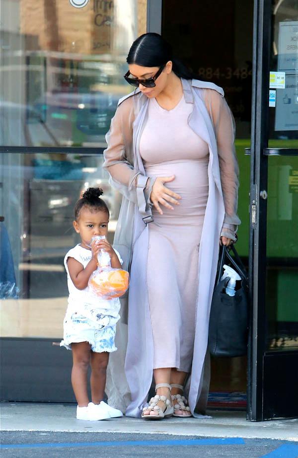 Pregnant Kim Kardashian seen with North West and Mason Disick at birthday party.